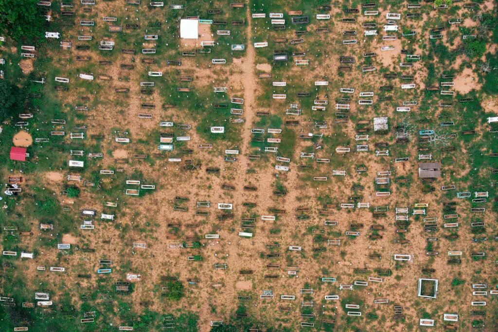 Top view of small trailers and shabby houses in poor suburbs of countryside on sandy terrain in daytime